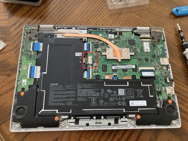 The back cover of the chromebook removed and the battery cable disconnected